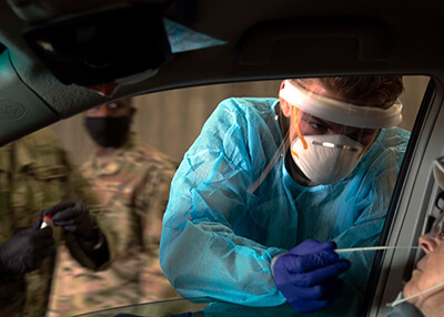 Soldiers with the Michigan Army National Guard, working with health care officials, conduct COVID-19 drive-through testing in Munising, Michigan, July 18.